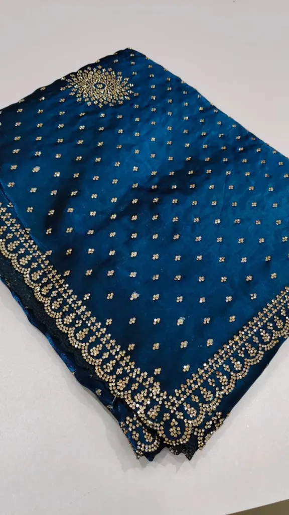 Teal blue stone-worked saree with golden mandallion motifs